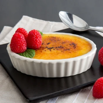 Tuxton BEK-0306 3 oz. Eggshell Oval Fluted China Souffle / Creme Brulee Dish - 24/Case