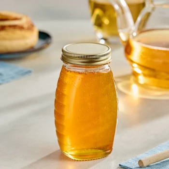 5.5 oz. (8 oz. Honey Weight) Classic Queenline Glass Honey Jar with Plastisol-Lined Gold Metal Lid - 96/Case