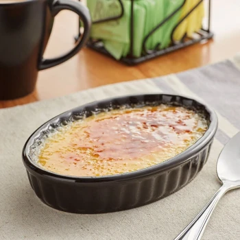 Acopa 6 oz. Oval Glossy Black Fluted Stoneware Souffle / Creme Brulee Dish - 36/Case