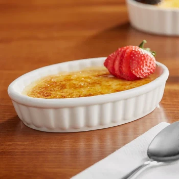 Acopa 6 oz. Oval Ivory Fluted Porcelain Souffle / Creme Brulee Dish - 36/Case