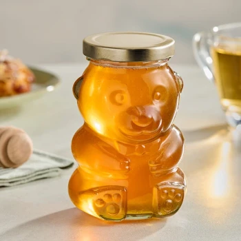8 oz. (12 oz. Honey Weight) Glass Bear Jar with Plastisol-Lined Gold Metal Lid - 96/Case