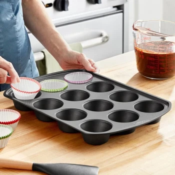 Wilton Perfect Results 15 inch x 10 1/2 inch 12-Compartment Non-Stick Steel Muffin / Cupcake Pan - 2 inch x 1 1/4 inch Cavities 191002982