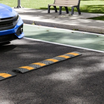 Lavex 6' Black and Yellow Heavy-Duty Rubber Speed Bump with 8 Cat Eye Reflectors and 5 Reflective Stripes